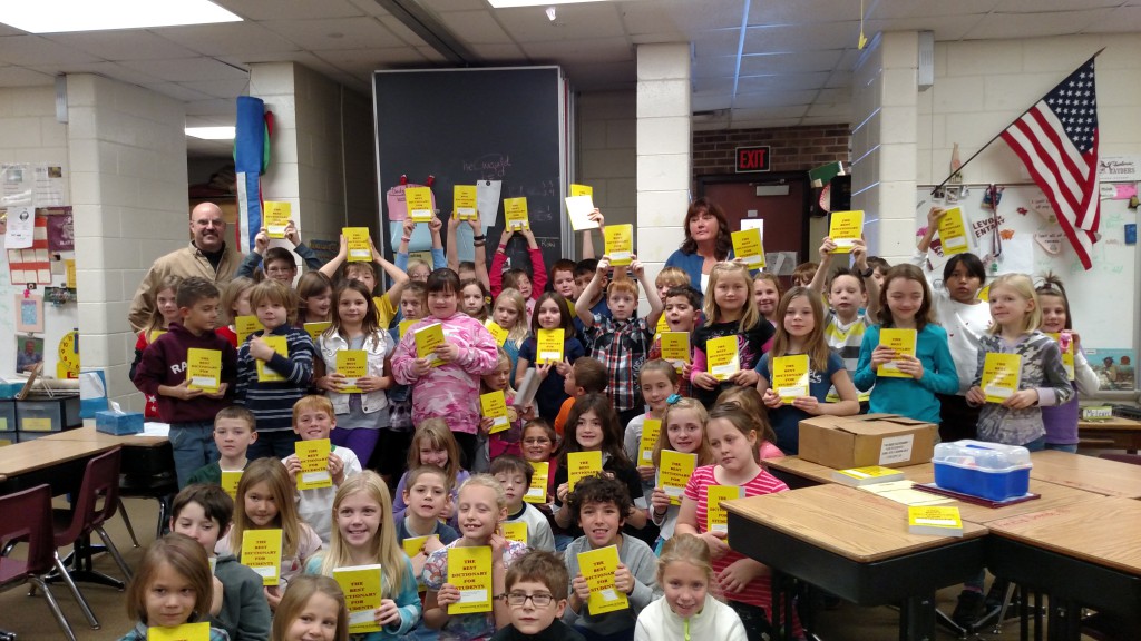 Exalted Ruler Ken Rogers and Elks member Margie Tamminga presented dictionaries to local third grade students.