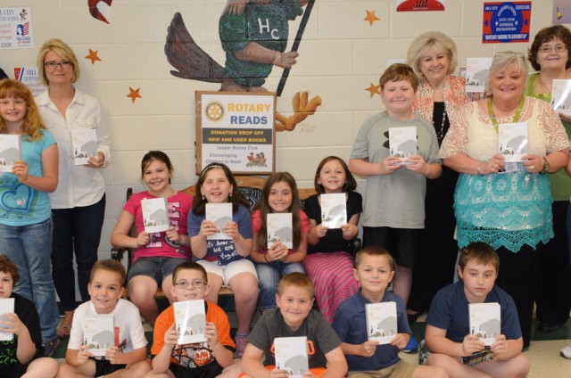 Rotarians Gina Pendley and Bob Payne, Dr. Lula Mae Perry, Superintendent and Rotarian, Principal Joeta Youngblood and teachers Becky Kuykendall and Kim Lunn with Hill City Elementary students.
