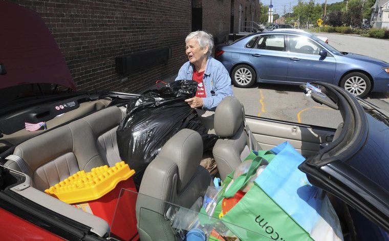 PAUL BILODEAU/Staff photo. Barbara McGovern, 79, of Andover, unloads her car of children