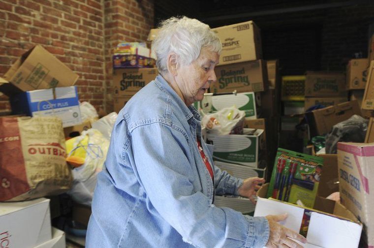 PAUL BILODEAU/Staff photo. Barbara McGovern, 79, of Andover, fills a storage room in Andover full of donations to help a West Virginia school.