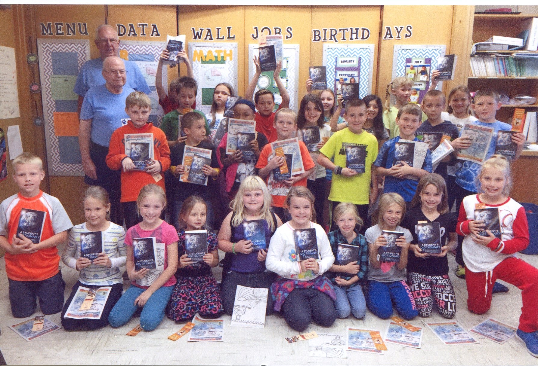 Proud students showing off their new dictionary.
