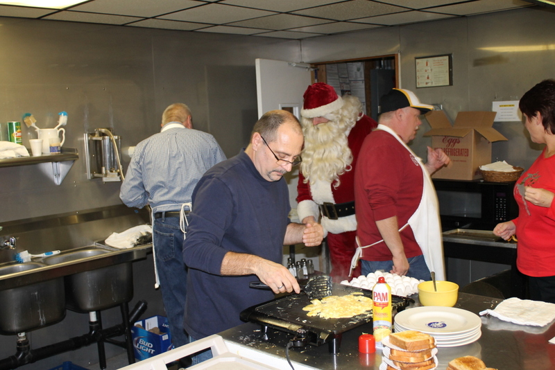 Members cooking breakfast prior to the toy give-away for over 80 volunteers.