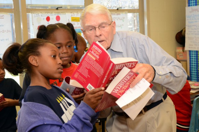 Club Member Tom Turner-assists students in using their dictionary.