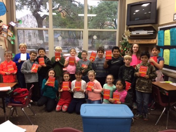Hunt School's third grade students show off their new dictionaries, which were a gift from the Republican Women of Kerr County.