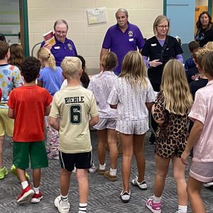 Lions Steve Hall, Rob Ginder, Craig Cooley, and Dr. Kathleen Busby pass out dictionaries. (Photo provided by Westfield Lions Club)