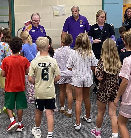 Lions Steve Hall, Rob Ginder, Craig Cooley, and Dr. Kathleen Busby pass out dictionaries. (Photo provided by Westfield Lions Club)