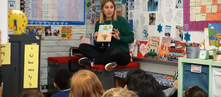 Teacher Jill Anderson reads to her class. Concerned about effects on students, Anderson has removed most screen time from her classroom. Photo Credit: Jackie Mader/The Hechinger Report